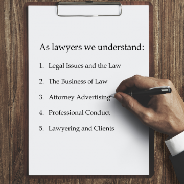 Business man hand writing on clipboard on wood desktop explaining our knowledge of the law and legal field